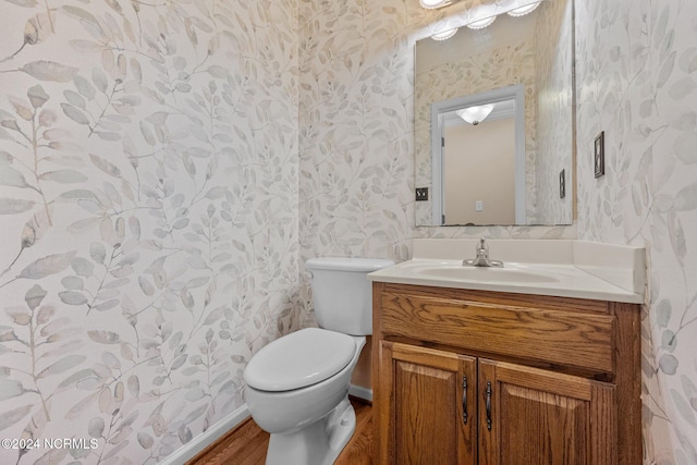 bathroom with vanity, hardwood / wood-style floors, and toilet