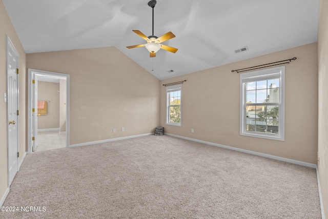 carpeted spare room featuring lofted ceiling and ceiling fan