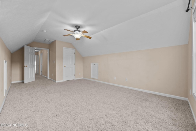 additional living space featuring lofted ceiling, ceiling fan, and carpet flooring