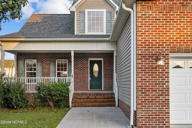 view of exterior entry featuring covered porch