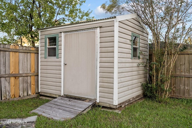 view of outbuilding featuring a lawn