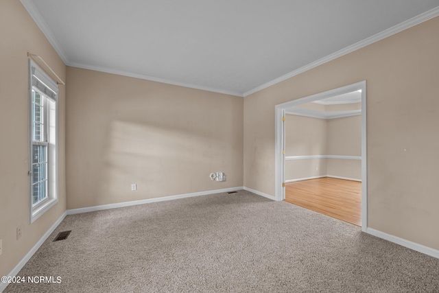 carpeted empty room featuring crown molding