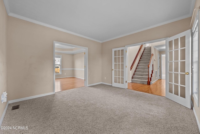 spare room featuring french doors, crown molding, and wood-type flooring