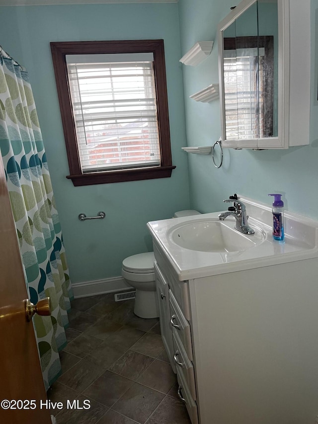 bathroom with vanity, toilet, and curtained shower