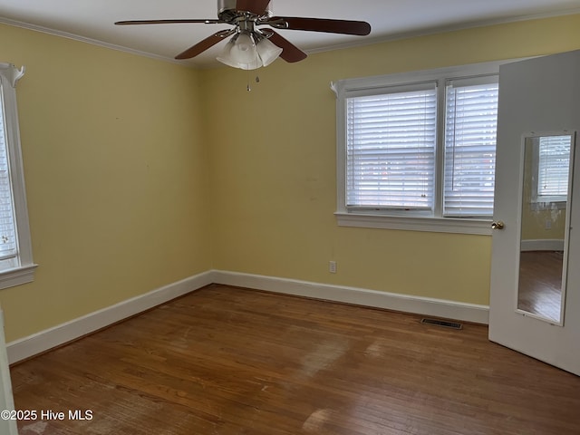 spare room featuring hardwood / wood-style floors, ceiling fan, and ornamental molding