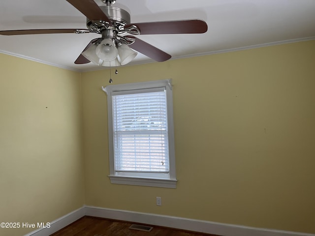 unfurnished room with ceiling fan, crown molding, and dark wood-type flooring