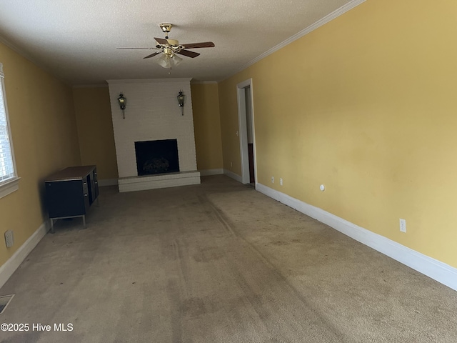 unfurnished living room with ornamental molding, a textured ceiling, light colored carpet, ceiling fan, and a fireplace