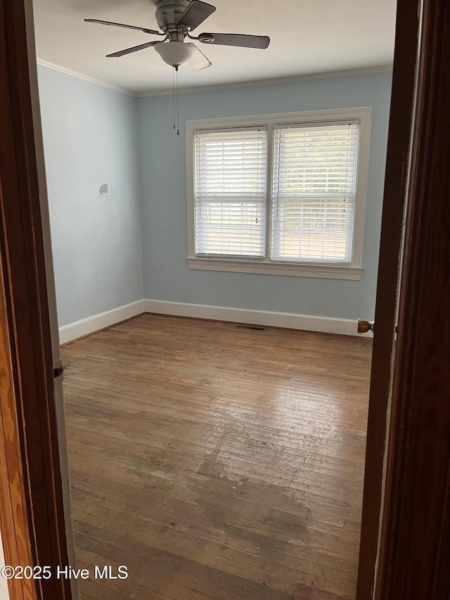 spare room with ceiling fan, hardwood / wood-style floors, and ornamental molding