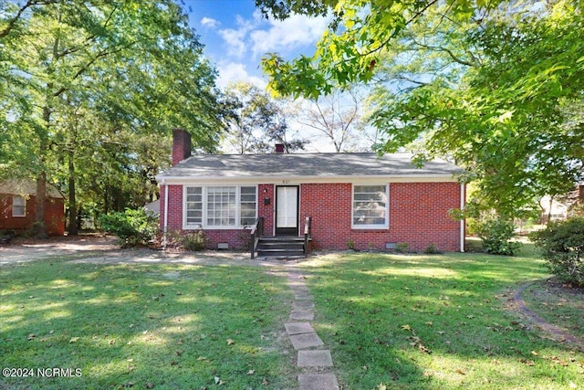 601 S Andrews Ave, Goldsboro, NC 27530 - view of front of home with brick siding, crawl space, a chimney, and a front yard
