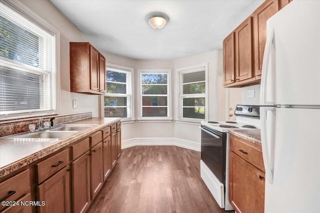 601 S Andrews Ave, Goldsboro, NC 27530 - kitchen featuring a sink, white appliances, brown cabinetry, baseboards, and dark wood-type flooring