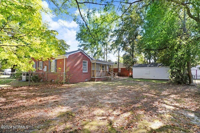 601 S Andrews Ave, Goldsboro, NC 27530 - view of yard with a porch, an outdoor structure, and fence