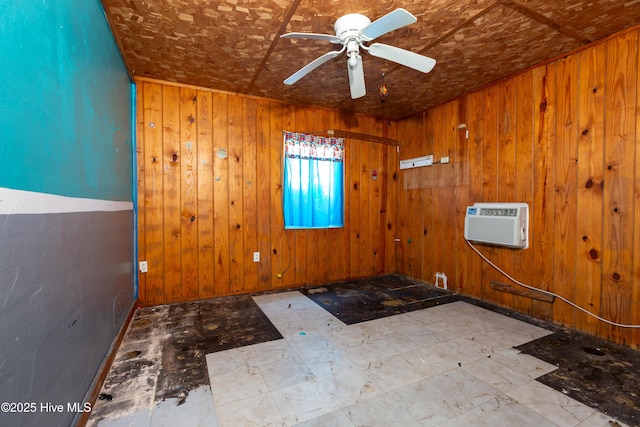 spare room featuring a wall mounted air conditioner, ceiling fan, and wooden walls