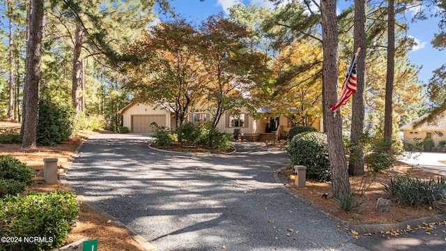 obstructed view of property with a garage