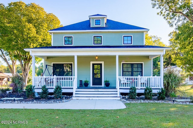 view of front facade with a porch and a front lawn