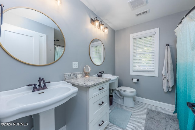 bathroom with sink, tile patterned flooring, and toilet