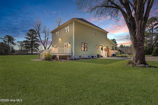 view of side of property featuring a yard, crawl space, concrete driveway, and a wooden deck