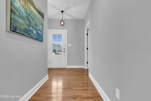 entryway with wood finished floors and baseboards