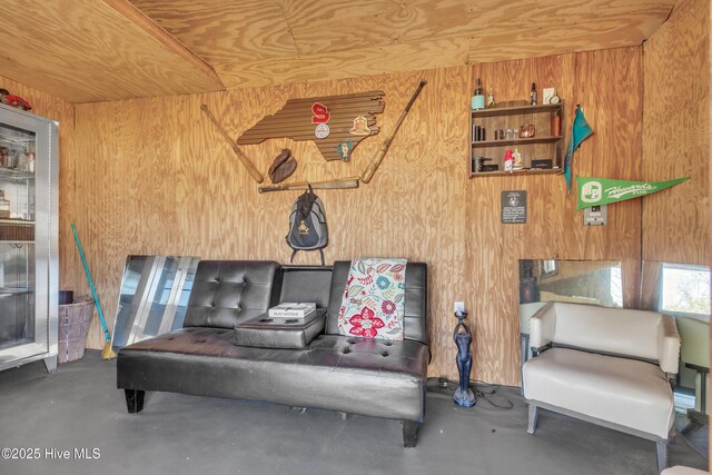 interior space with wood walls and concrete floors