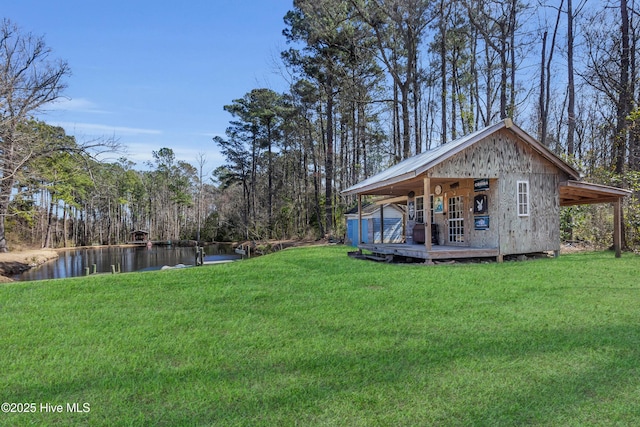 view of yard featuring a water view and a forest view