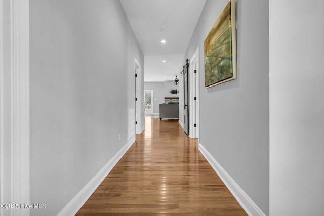 laundry room with washer and clothes dryer and wood-type flooring