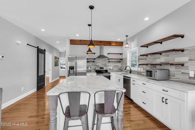 kitchen with pendant lighting, stainless steel appliances, and plenty of natural light