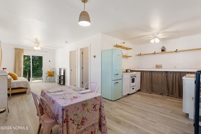 kitchen with light wood-type flooring, ceiling fan, and decorative light fixtures