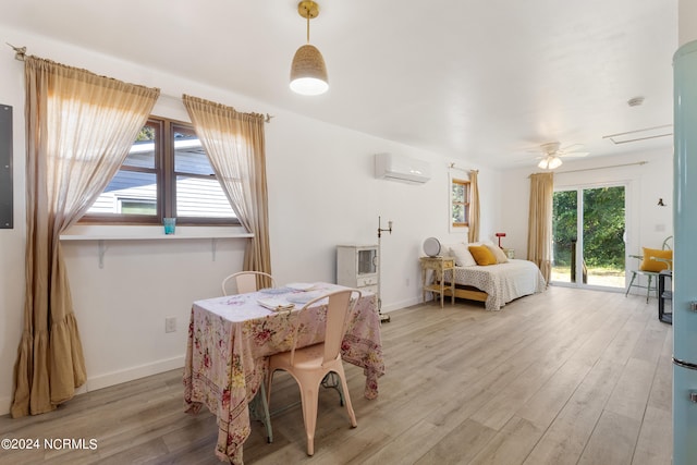 bedroom featuring light wood-type flooring, ceiling fan, electric panel, access to exterior, and a wall mounted AC