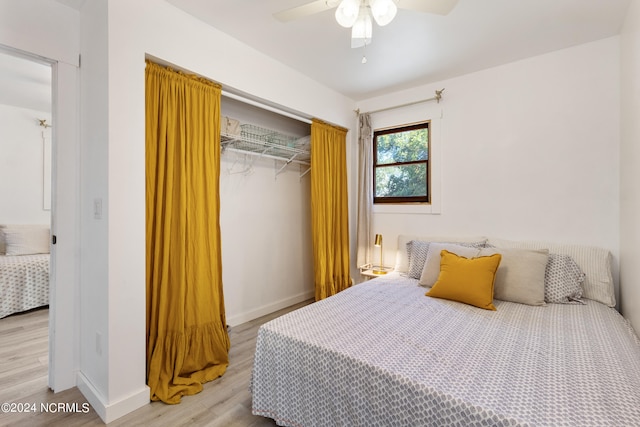 bedroom featuring a closet, light hardwood / wood-style floors, and ceiling fan