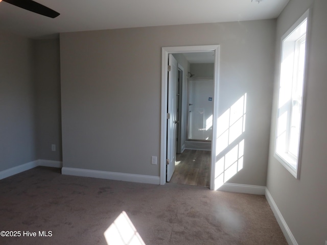 unfurnished room featuring dark carpet