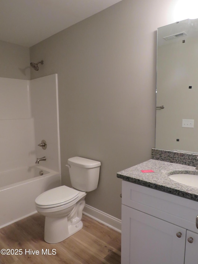 full bathroom with toilet, vanity, wood-type flooring, and shower / washtub combination