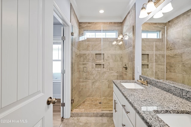 bathroom featuring a wealth of natural light, vanity, and an enclosed shower