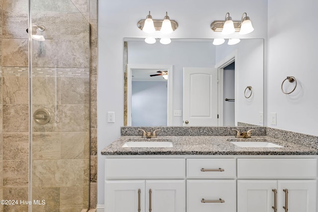 bathroom featuring a tile shower, vanity, and ceiling fan