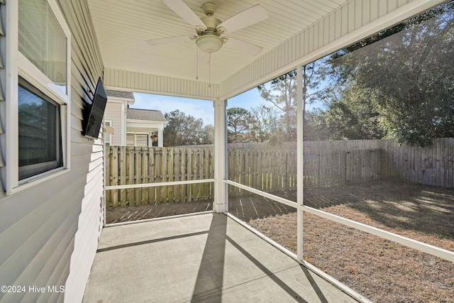 unfurnished sunroom with ceiling fan