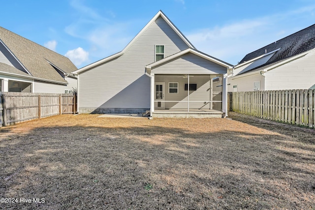 rear view of property featuring a sunroom