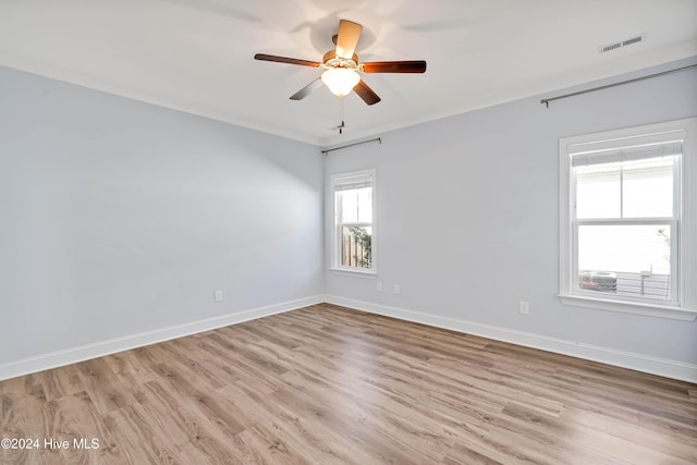 unfurnished room with plenty of natural light, ceiling fan, and light hardwood / wood-style flooring