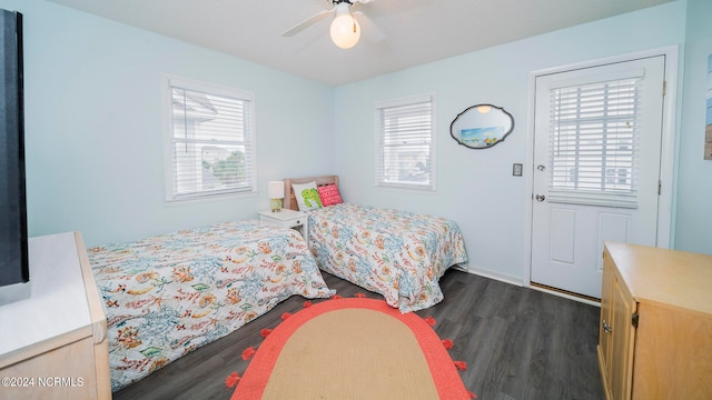 bedroom featuring dark wood-style floors, multiple windows, and ceiling fan