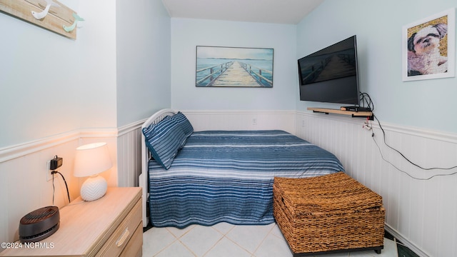 bedroom featuring a wainscoted wall