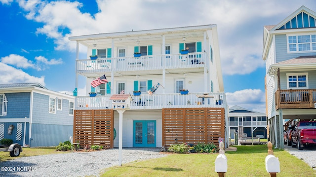 coastal inspired home with a front lawn