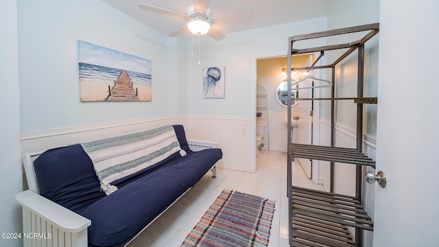 sitting room featuring ceiling fan, light tile patterned floors, and radiator heating unit