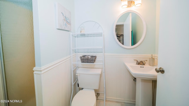 bathroom with sink, tile patterned floors, and toilet