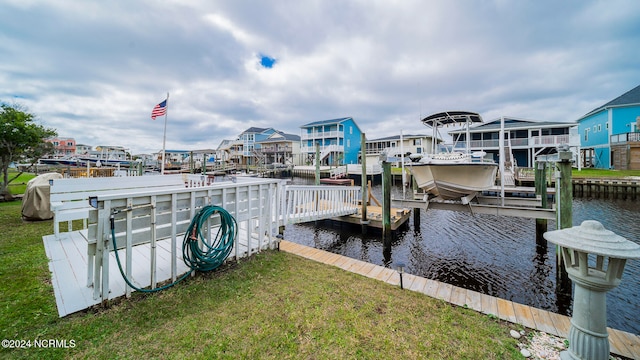 view of dock featuring a water view and a yard