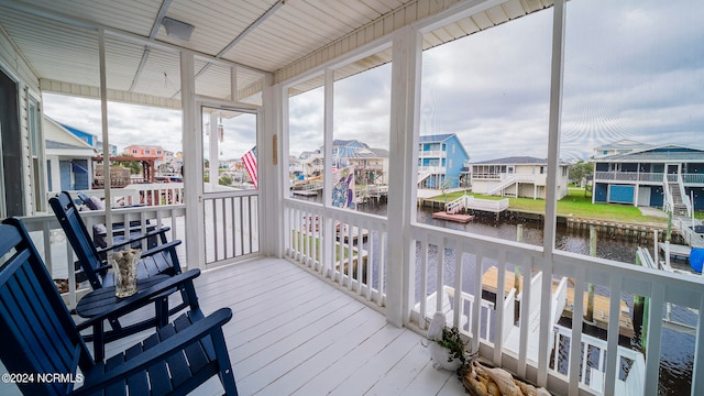 sunroom / solarium with a water view