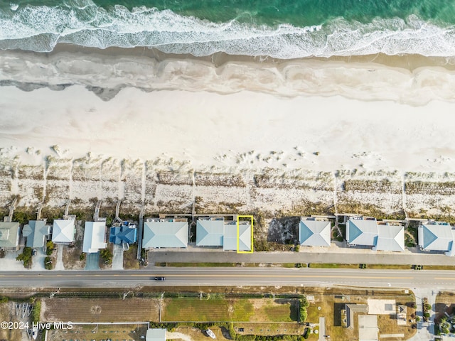 birds eye view of property featuring a view of the beach and a water view