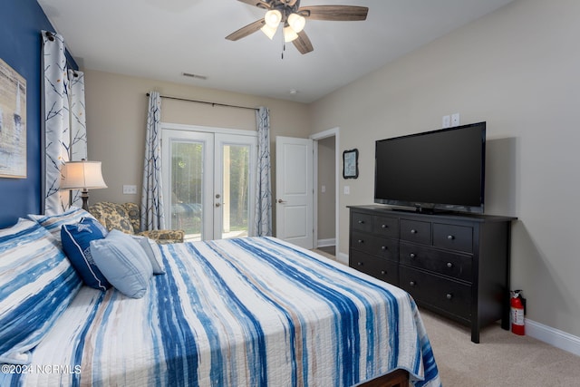 carpeted bedroom featuring french doors, ceiling fan, and access to outside