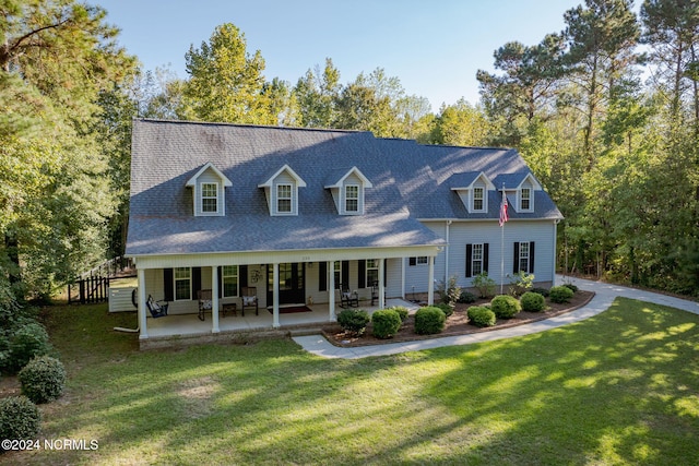 cape cod house with a patio area and a front yard