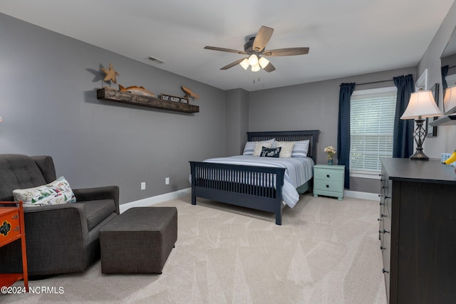 bedroom with ceiling fan and light colored carpet