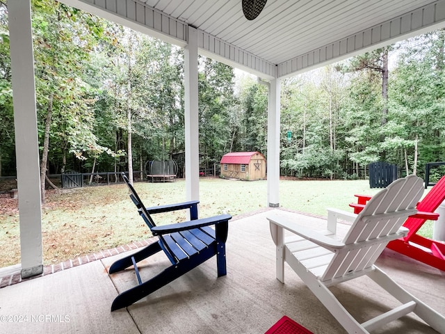 view of patio with a storage unit and a trampoline