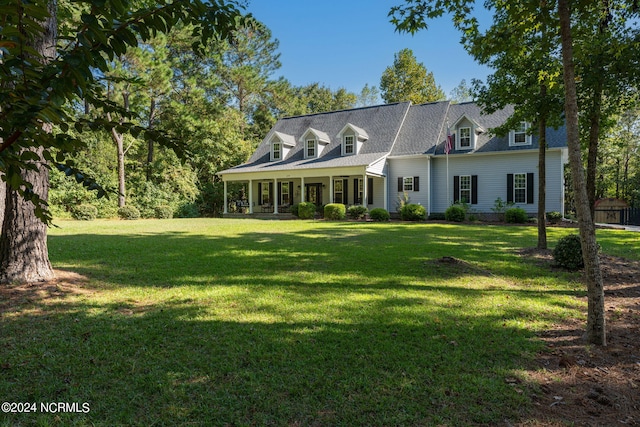 cape cod-style house featuring a front yard and covered porch