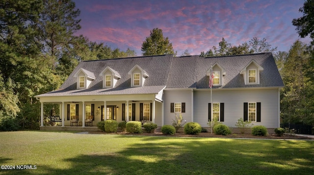 view of front facade with a yard and covered porch