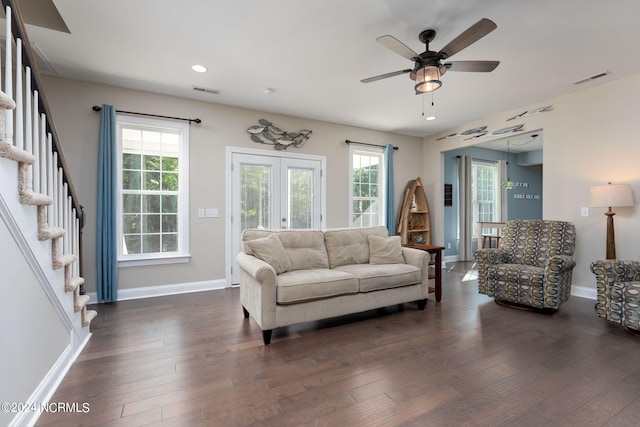 living room with dark wood-type flooring, french doors, and ceiling fan